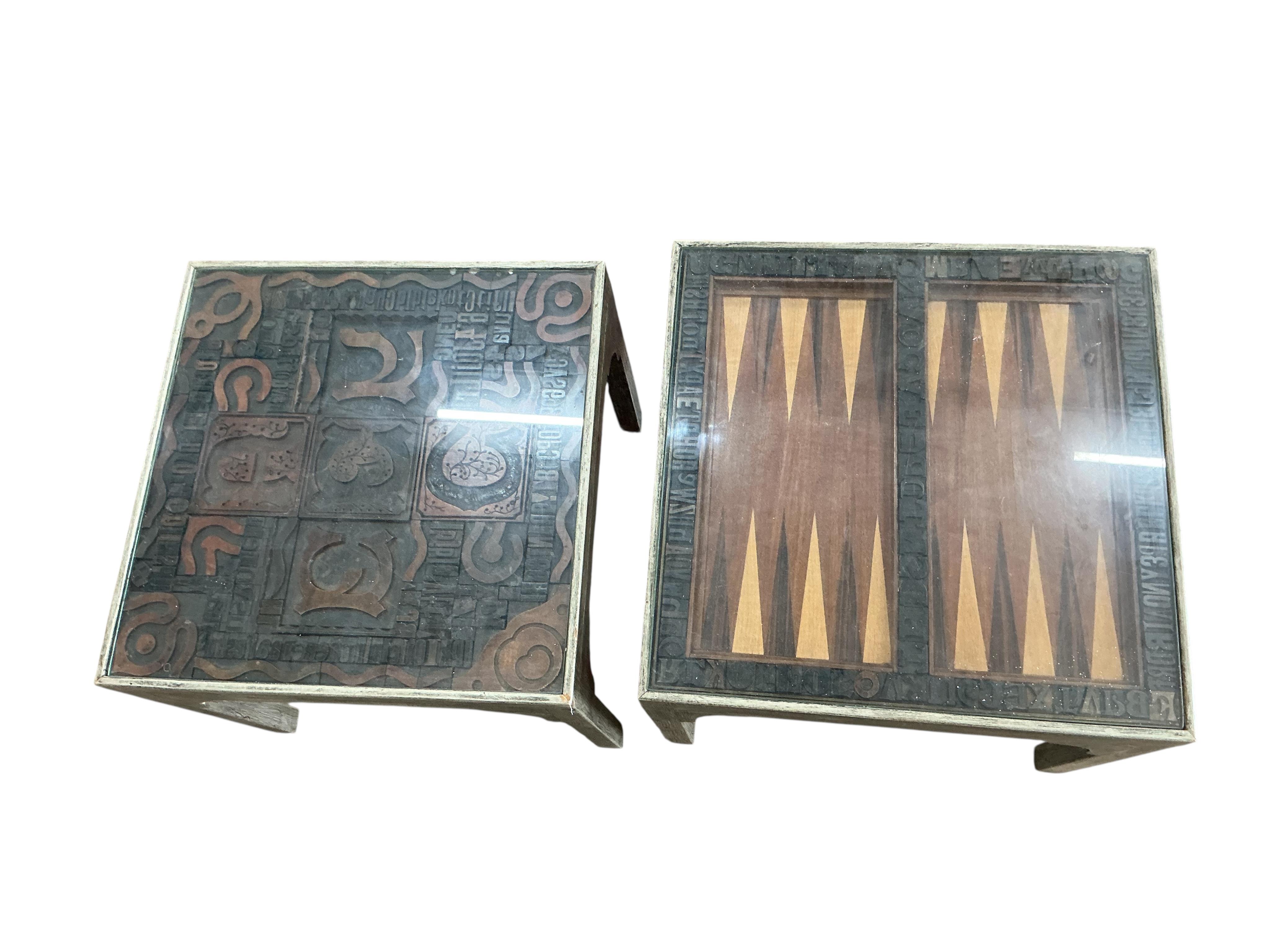 A pair of grey painted printing block inset lamp tables, one with backgammon board, width 47cm, depth 47cm, height 42cm